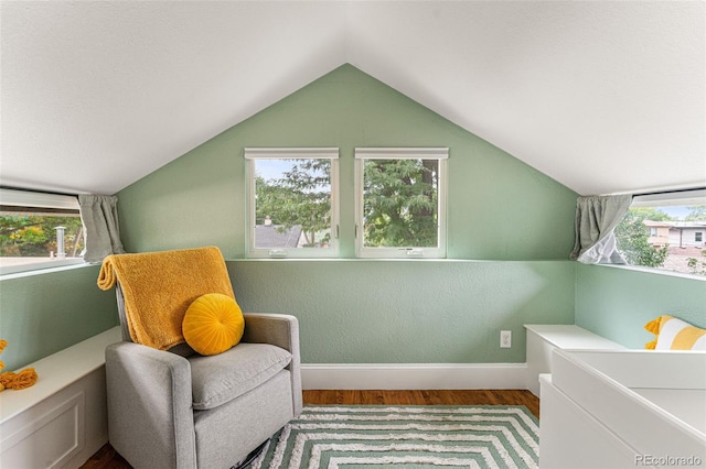 sitting room featuring vaulted ceiling, wood finished floors, and baseboards