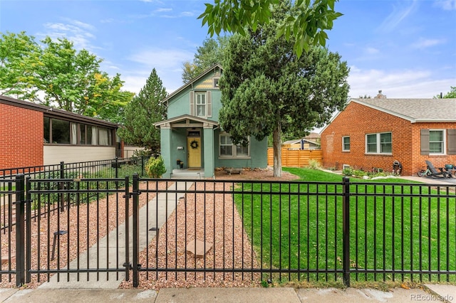 view of front of house featuring a fenced front yard, a front yard, a gate, and stucco siding