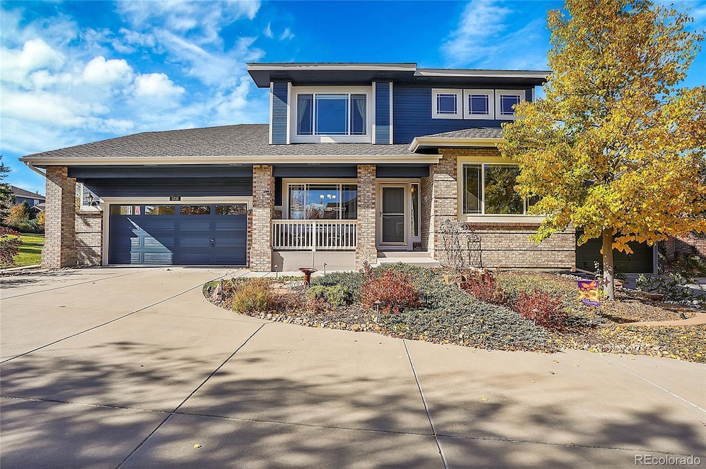 prairie-style house featuring covered porch and a garage