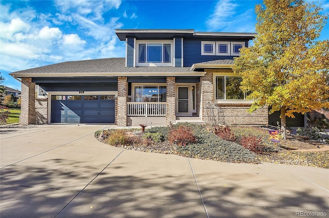 prairie-style house featuring covered porch and a garage