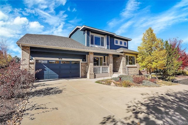 view of front of property with a porch and a garage