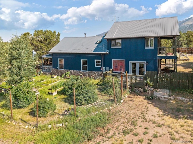 274 N Willow St, Crestone, CO 81131 - rear view of property with a garden, a metal roof, and a deck