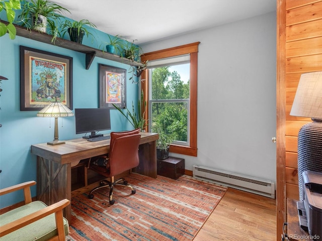 274 N Willow St, Crestone, CO 81131 - home office featuring a baseboard heating unit and wood finished floors