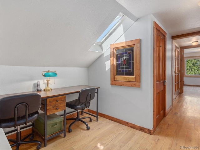 274 N Willow St, Crestone, CO 81131 - office area with a skylight, light wood-style floors, lofted ceiling, and a textured ceiling