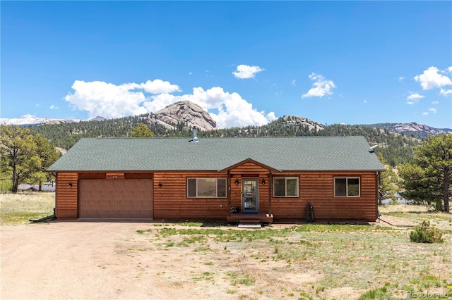 874 Hackamore Dr, Florissant, CO 80816 - log-style house with a mountain view, a garage, and dirt driveway