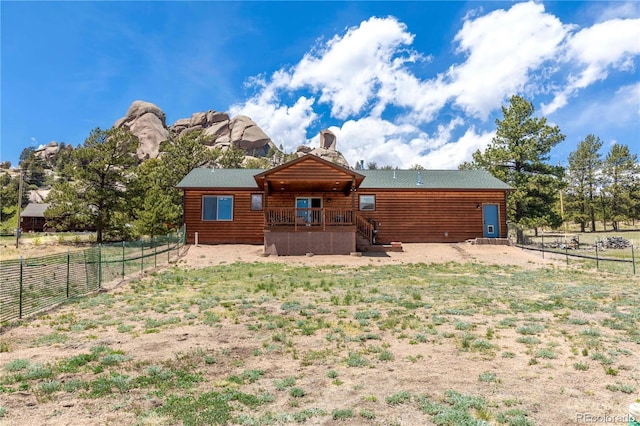 874 Hackamore Dr, Florissant, CO 80816 - rear view of house with a fenced backyard and a deck