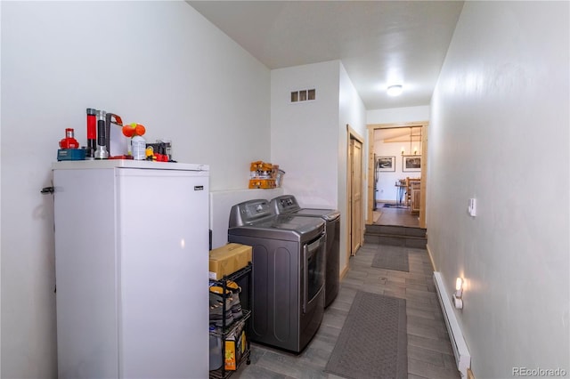 874 Hackamore Dr, Florissant, CO 80816 - washroom with washing machine and clothes dryer, baseboard heating, and baseboards