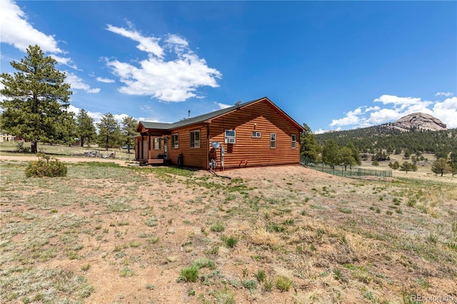 874 Hackamore Dr, Florissant, CO 80816 - rear view of property with faux log siding and a mountain view