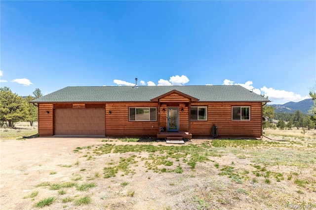 874 Hackamore Dr, Florissant, CO 80816 - log home featuring an attached garage, driveway, and a mountain view