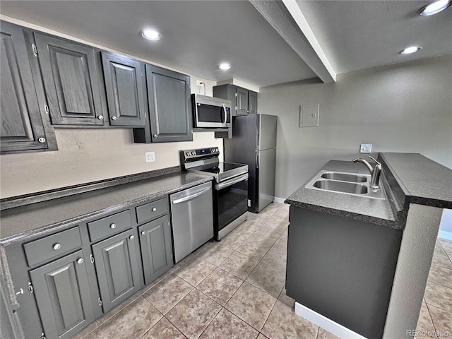 371 S Estes St Unit 10, Lakewood, CO 80226 - kitchen featuring appliances with stainless steel finishes, a sink, dark countertops, light tile patterned flooring, and recessed lighting