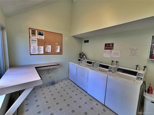 371 S Estes St Unit 10, Lakewood, CO 80226 - community laundry room with independent washer and dryer, light floors, and a towering ceiling