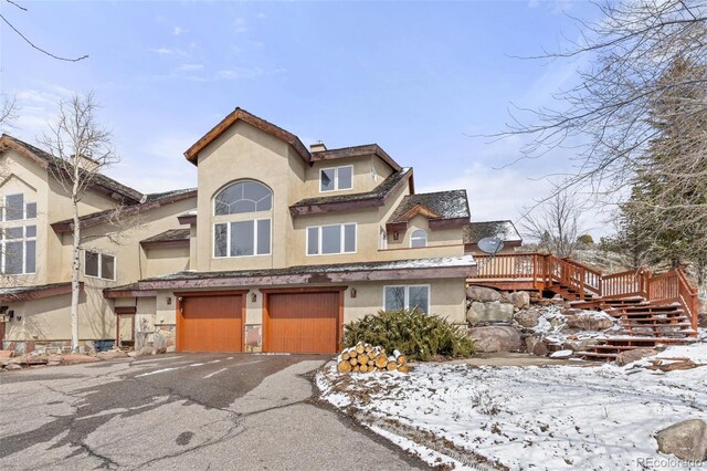 11 Hackamore Rd Unit B, Edwards, CO 81632 - view of front of house featuring stucco siding, an attached garage, and aphalt driveway