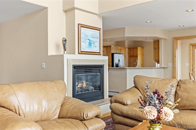 11 Hackamore Rd Unit B, Edwards, CO 81632 - living area featuring a glass covered fireplace, recessed lighting, and a baseboard radiator
