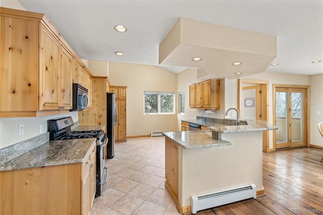 11 Hackamore Rd Unit B, Edwards, CO 81632 - kitchen with a peninsula, baseboard heating, plenty of natural light, and appliances with stainless steel finishes