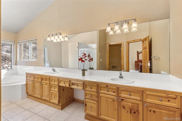 11 Hackamore Rd Unit B, Edwards, CO 81632 - full bathroom with vaulted ceiling, a bath, tile patterned floors, and a sink