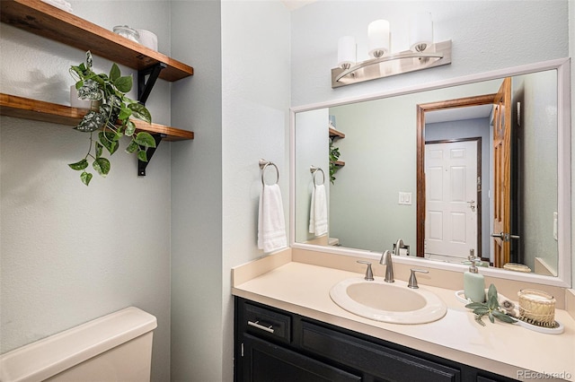 half bath featuring toilet and vanity