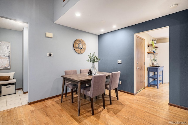 dining room featuring light wood-style floors, baseboards, and recessed lighting