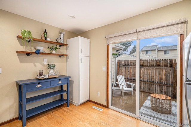 entryway featuring light wood-type flooring and baseboards