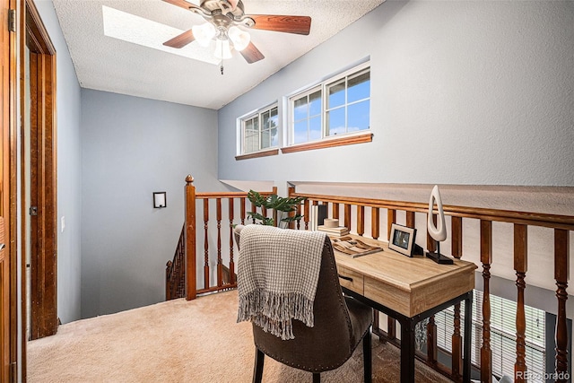 living area with an upstairs landing, carpet flooring, a ceiling fan, and a textured ceiling
