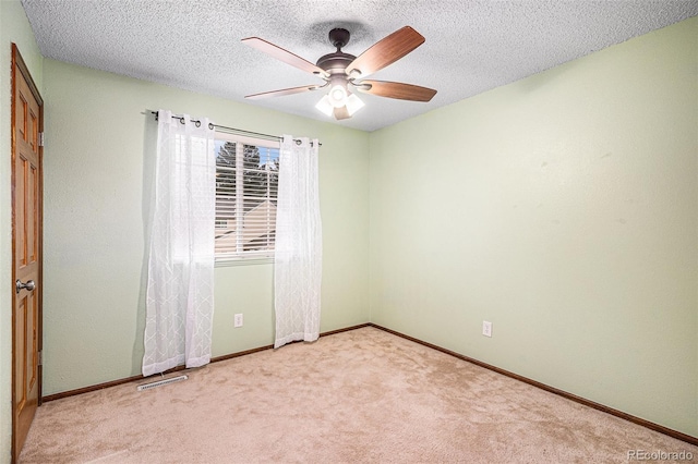 unfurnished room featuring a ceiling fan, carpet flooring, baseboards, and a textured ceiling