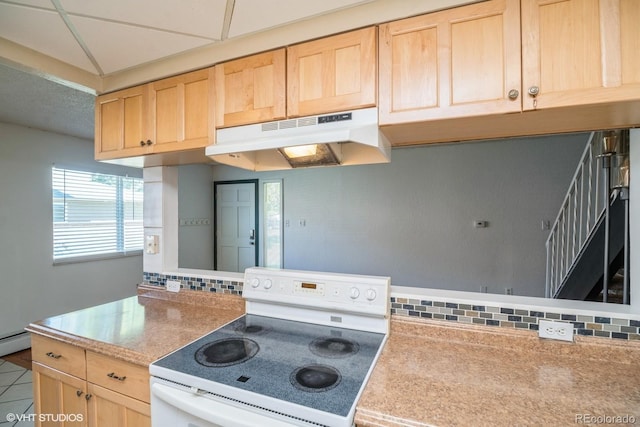 kitchen with white range with electric stovetop, light brown cabinets, and tile patterned flooring