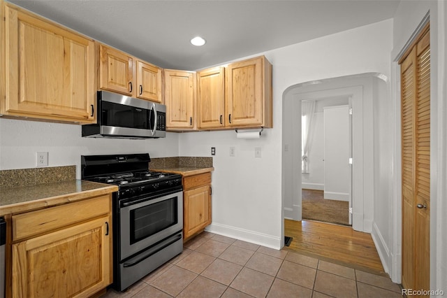 502 E San Miguel St, Colorado Springs, CO 80903 - kitchen featuring appliances with stainless steel finishes, light tile patterned floors, light brown cabinets, recessed lighting, and tile counters