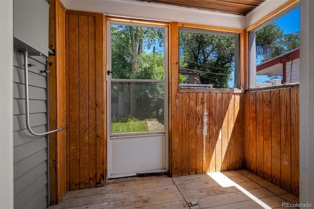 502 E San Miguel St, Colorado Springs, CO 80903 - doorway to outside featuring plenty of natural light, wood-type flooring, and wood walls