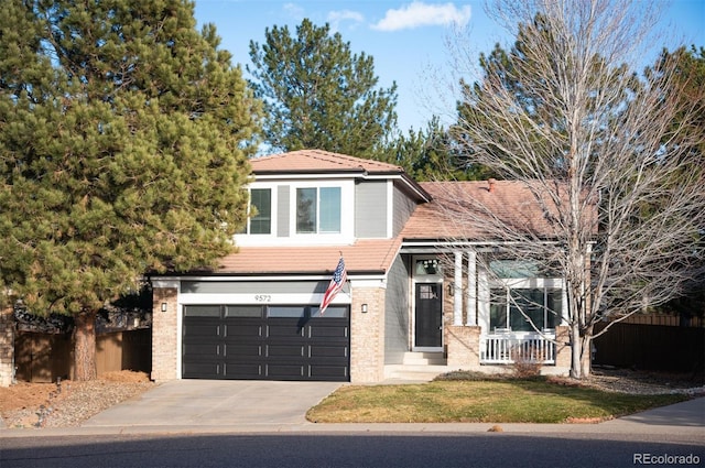 view of front of property featuring a front yard and a garage