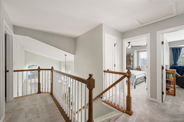 hallway featuring light colored carpet