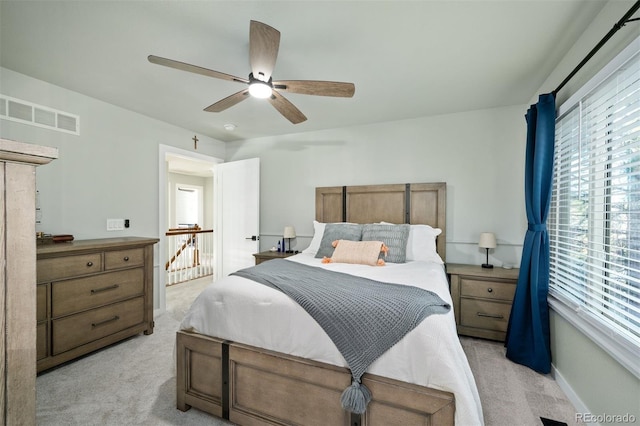 bedroom with light carpet and ceiling fan