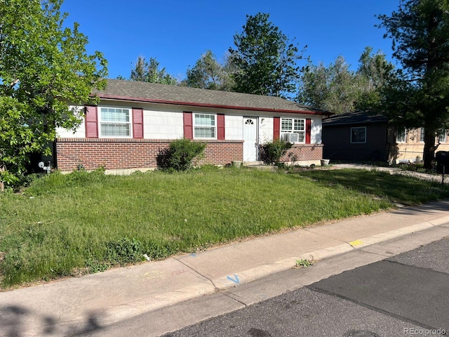 5543 Victor St, Denver, CO 80239 - ranch-style house with brick siding and a front lawn