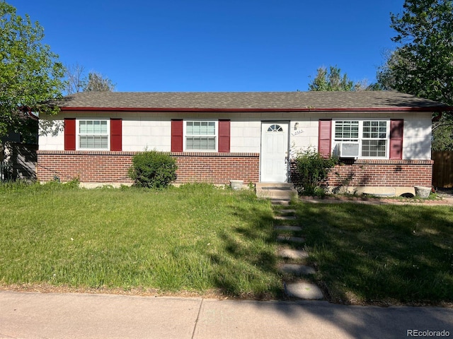 5543 Victor St, Denver, CO 80239 - single story home featuring brick siding, a front lawn, and cooling unit
