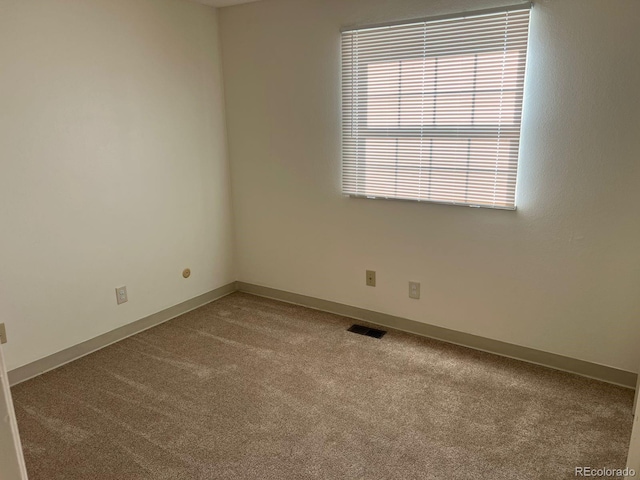 5543 Victor St, Denver, CO 80239 - carpeted spare room with plenty of natural light and baseboards