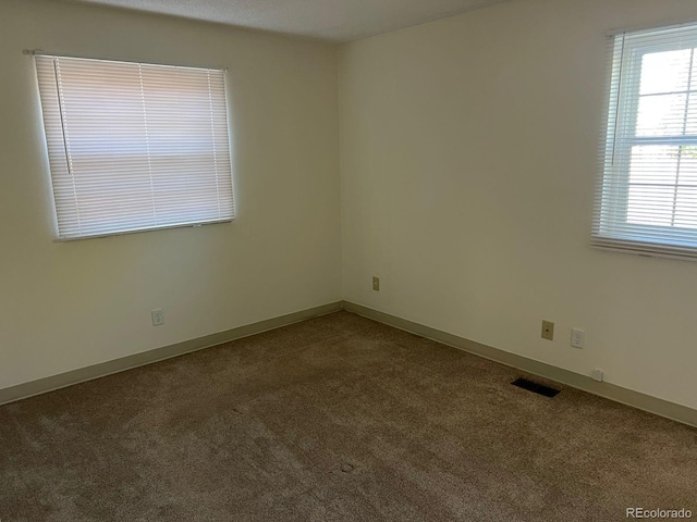 5543 Victor St, Denver, CO 80239 - carpeted spare room featuring baseboards