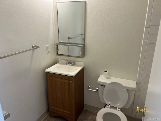 5543 Victor St, Denver, CO 80239 - bathroom with toilet, vanity, and baseboards