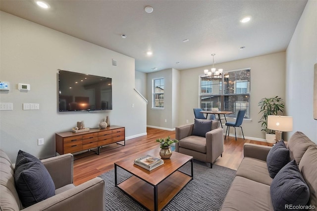 living room with wood-type flooring and a chandelier