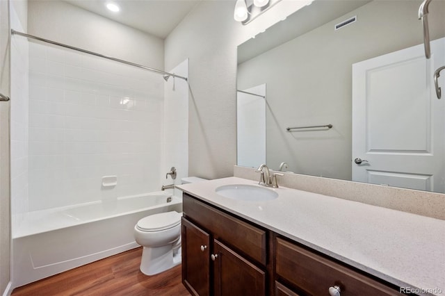 full bathroom featuring hardwood / wood-style flooring, vanity, toilet, and bathtub / shower combination