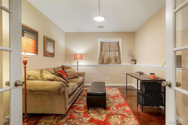 living area with visible vents and baseboards