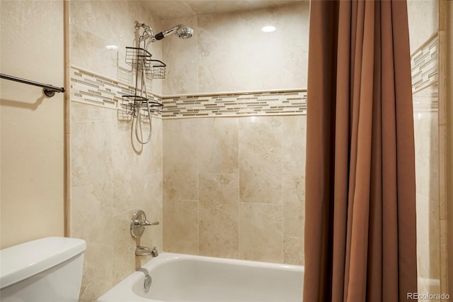 bathroom featuring toilet and shower / bath combo with shower curtain