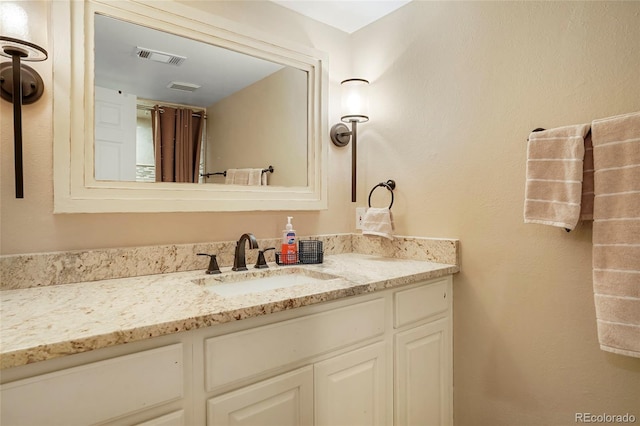 bathroom with visible vents and vanity