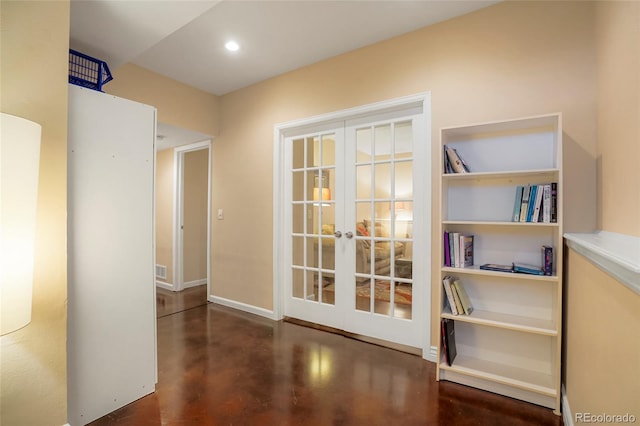 hall featuring french doors, finished concrete flooring, recessed lighting, visible vents, and baseboards