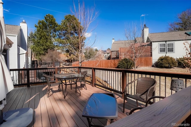 wooden deck with fence and outdoor dining area