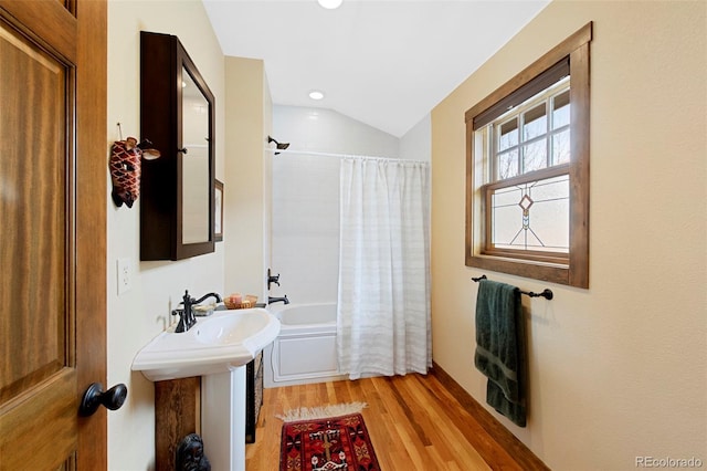 full bathroom featuring shower / bath combo, recessed lighting, wood finished floors, and lofted ceiling