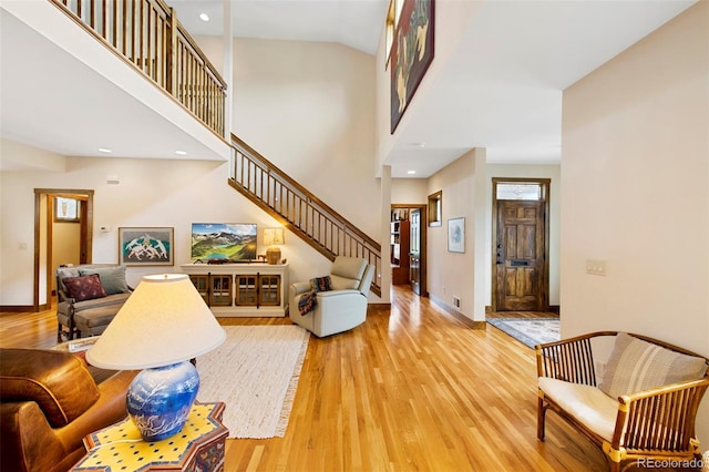 interior space with recessed lighting, baseboards, light wood-style flooring, and stairway