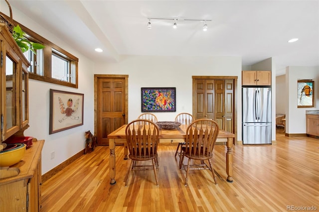 dining room with recessed lighting, baseboards, track lighting, and light wood-type flooring