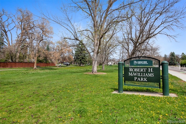 surrounding community with a lawn and fence