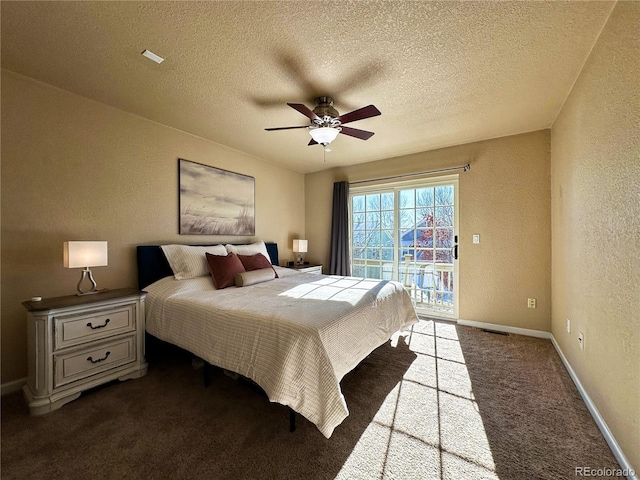 carpeted bedroom featuring access to outside, ceiling fan, and a textured ceiling