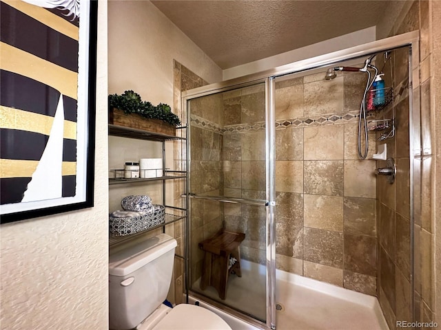 bathroom featuring a textured ceiling and toilet