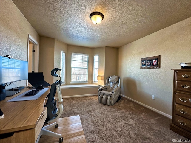 home office featuring carpet flooring and a textured ceiling