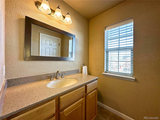 bathroom featuring tile patterned flooring and vanity